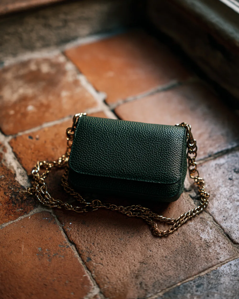 The Sera small crossbody in forest green pebbled calfskin with chain strap